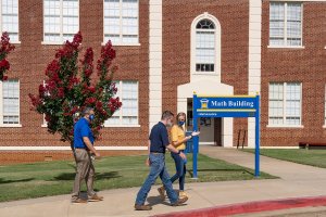 student getting a tour in front of the math building