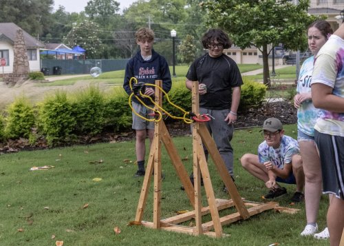 4 students using a catapult 