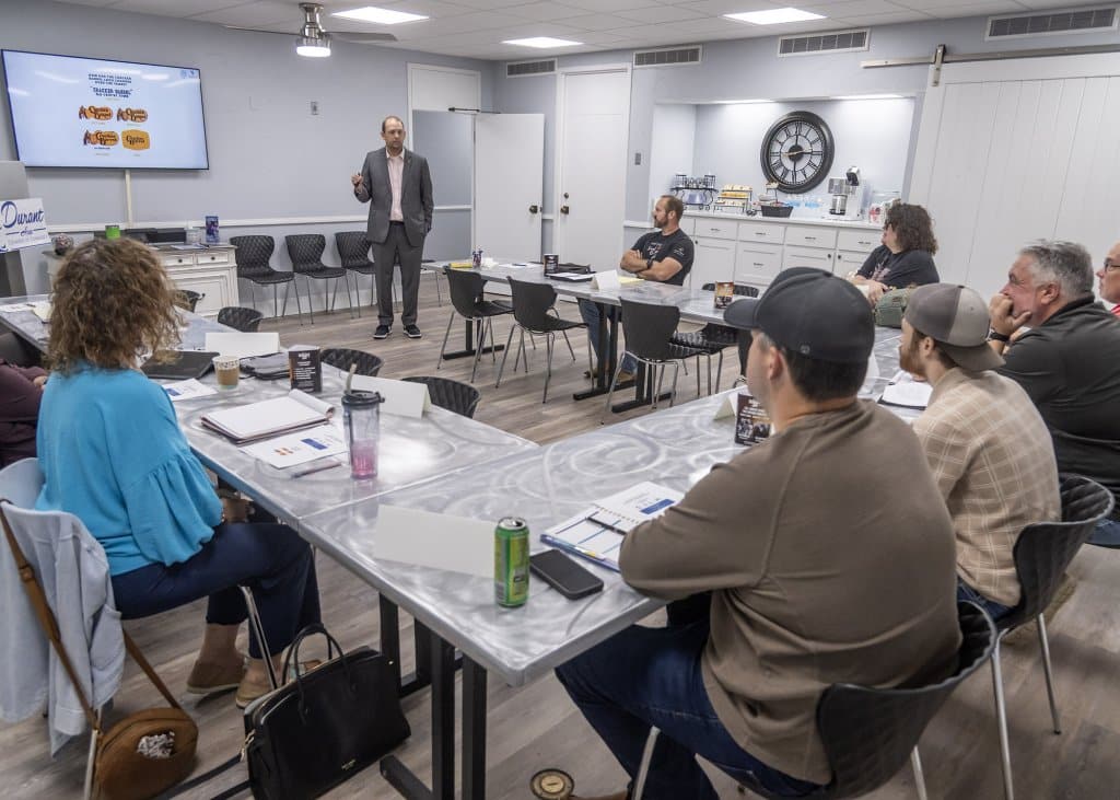 Dr. Eric Kennedy speaking in a classroom setting at the Durant Area Chamber of Commerce
