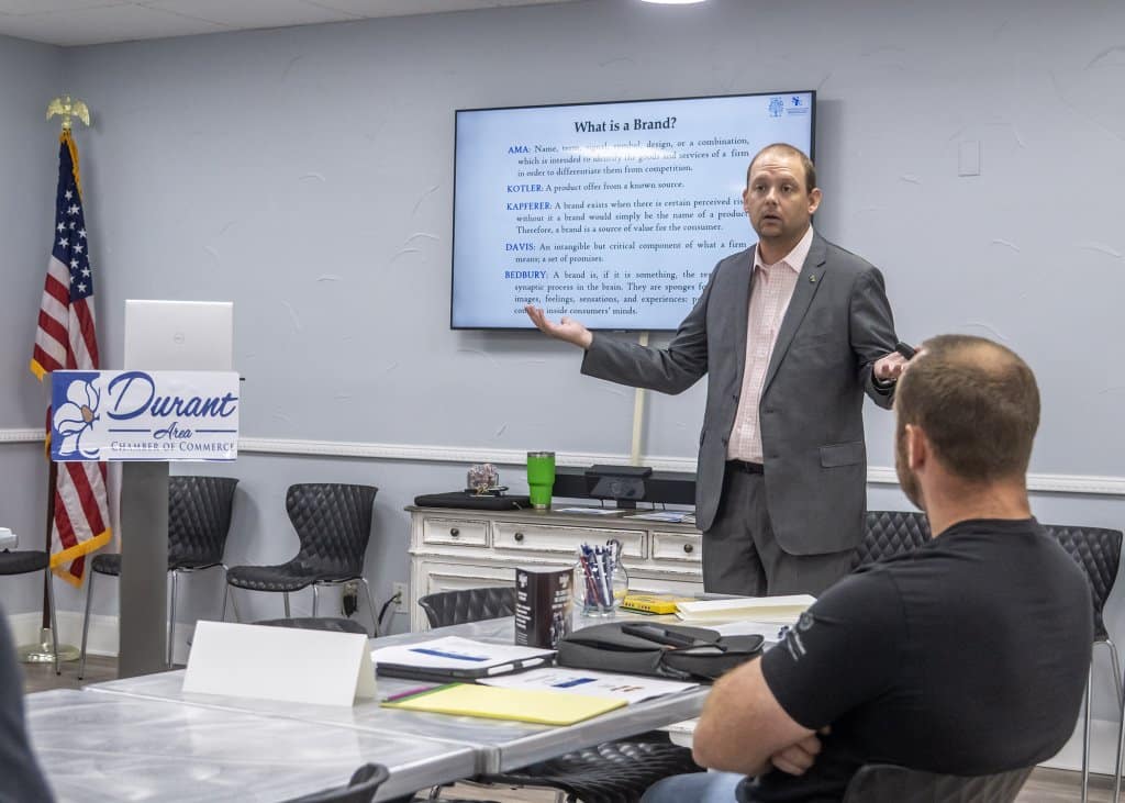 Dr. Eric Kennedy speaking in a classroom setting at the Durant Area Chamber of Commerce