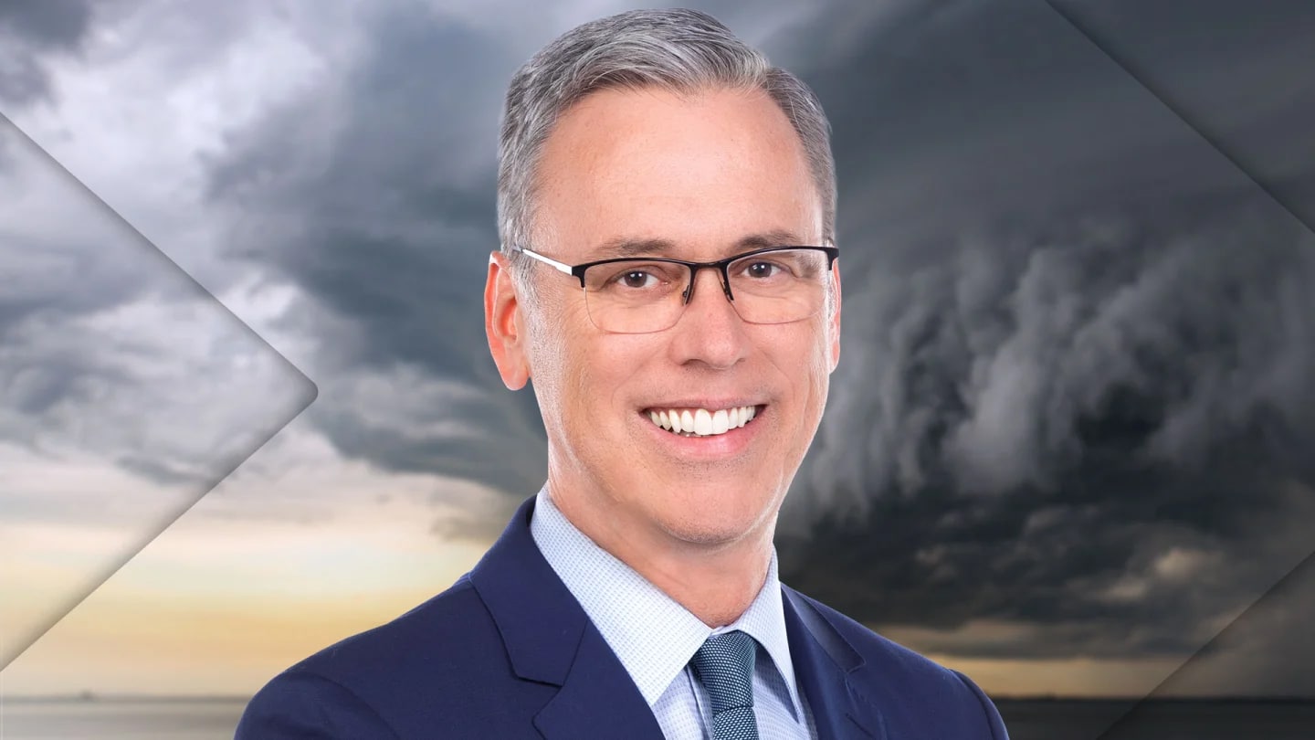 A headshot of weatherman Alan Crone in front of a severe weather cloud storm