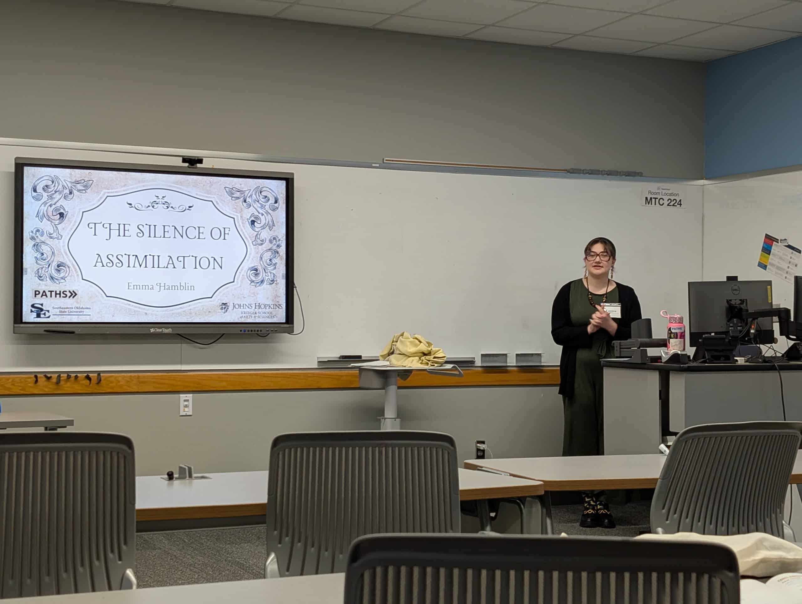 A woman presenting in a classroom