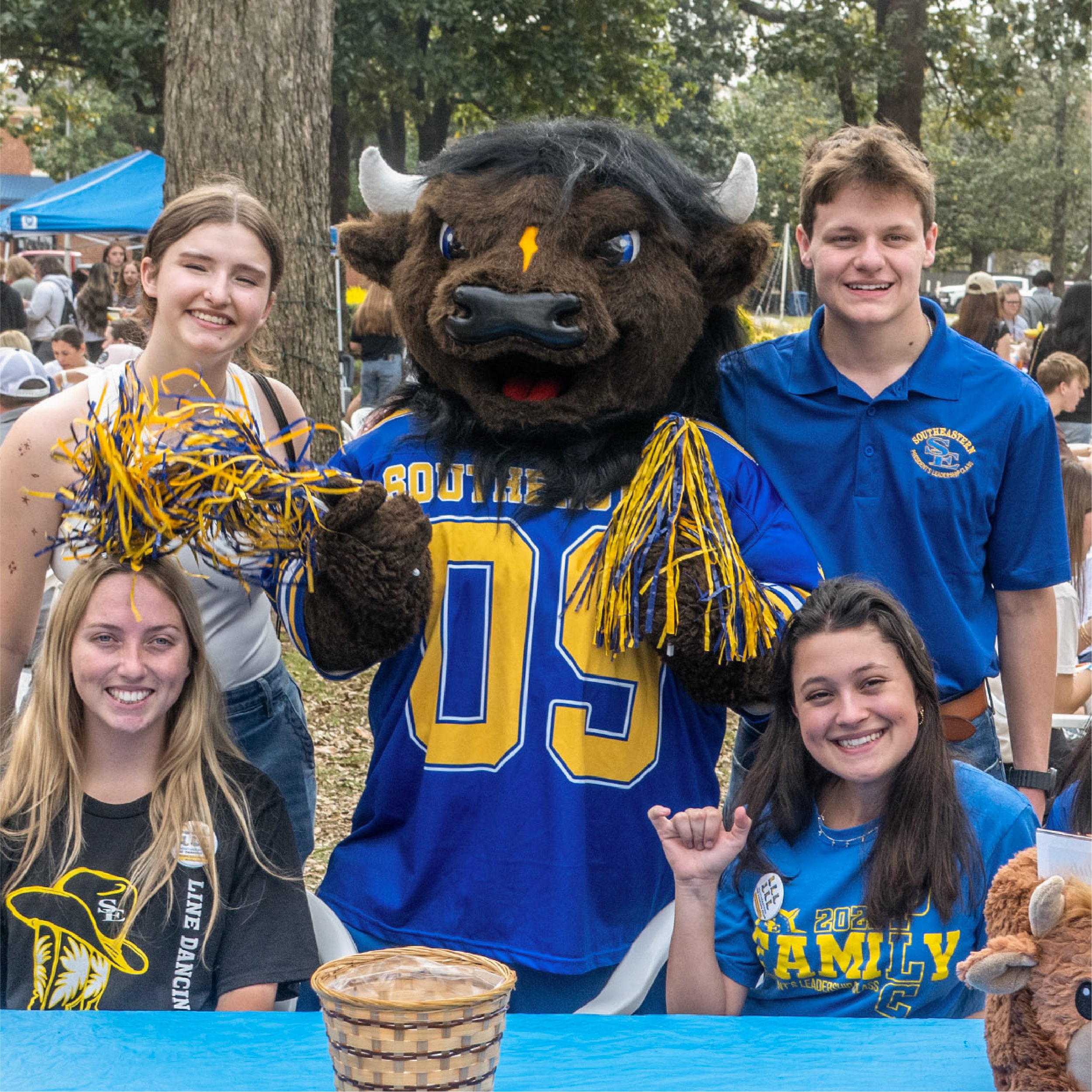 Students smiling with Bison Mascot