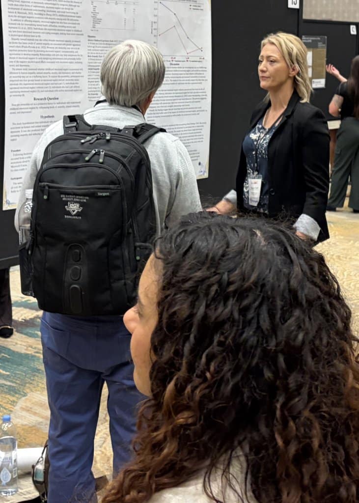 People engaging with academic posters at a conference.